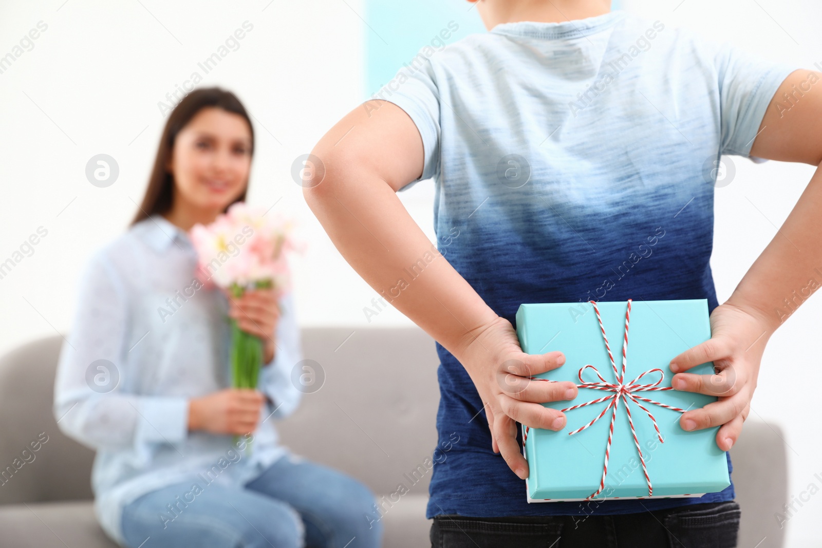 Photo of Little son congratulating his mom at home, space for text. Happy Mother's Day