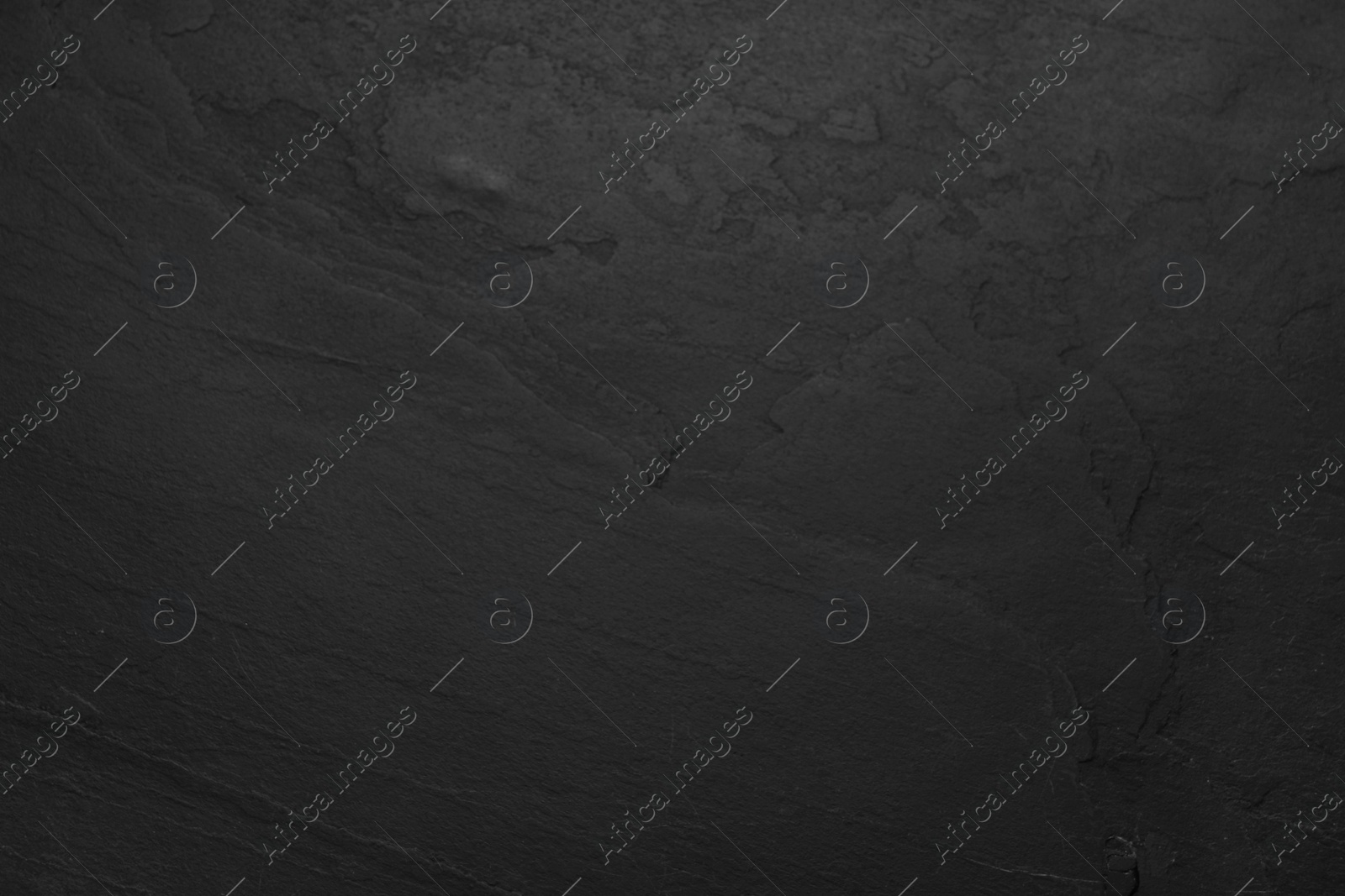 Photo of Texture of black stone surface as background, closeup