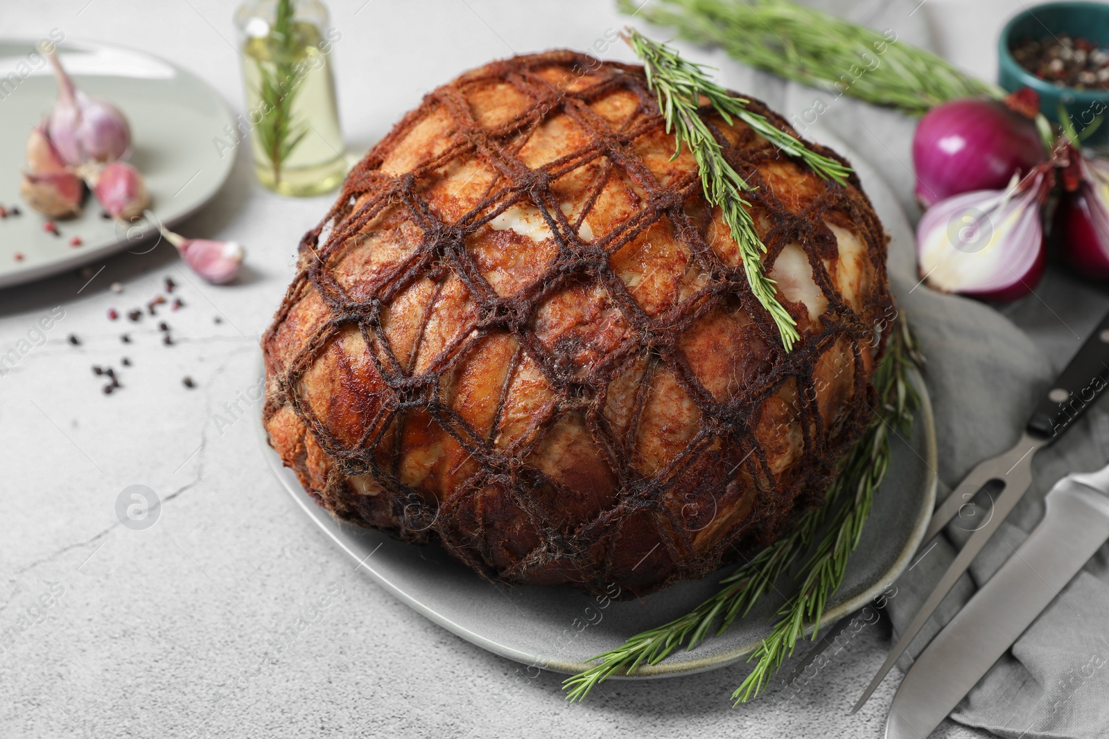 Photo of Delicious baked ham served on light grey table, closeup