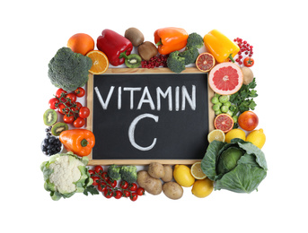 Photo of Chalkboard with phrase VITAMIN C and fresh products on white background
