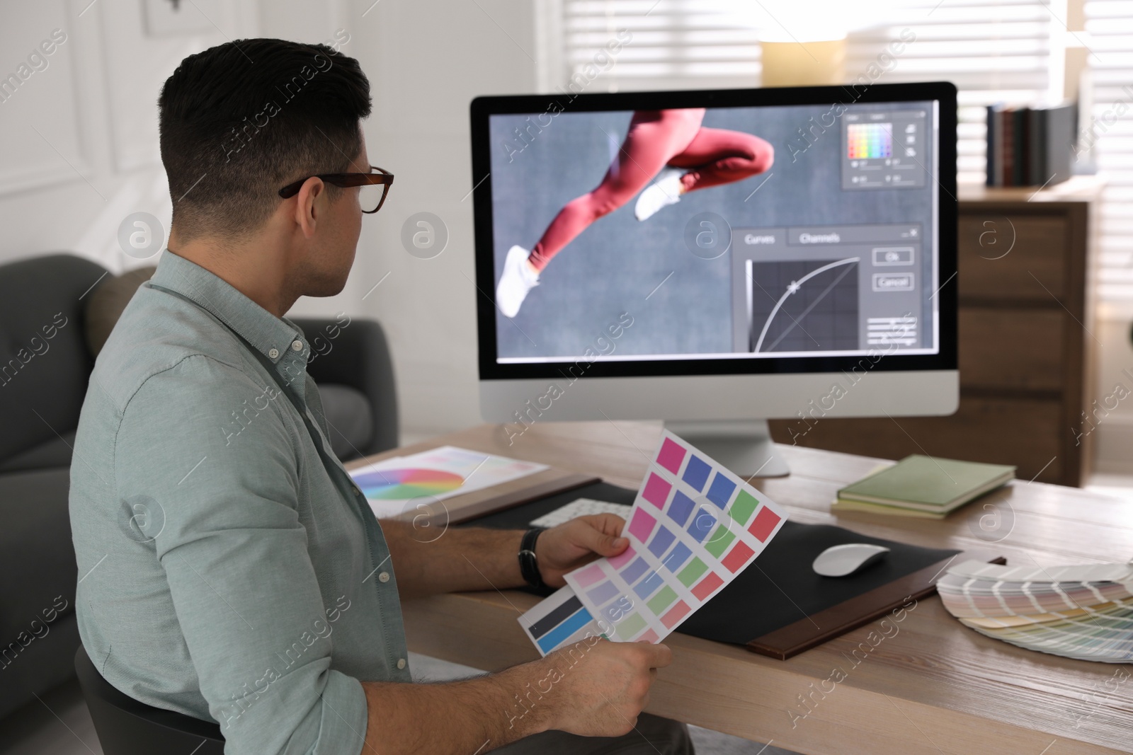 Photo of Professional retoucher working on computer in office