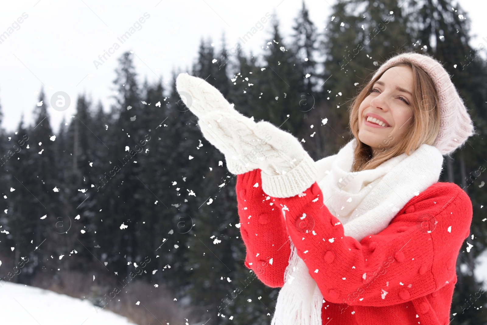 Photo of Happy young woman in warm clothes outdoors. Winter vacation