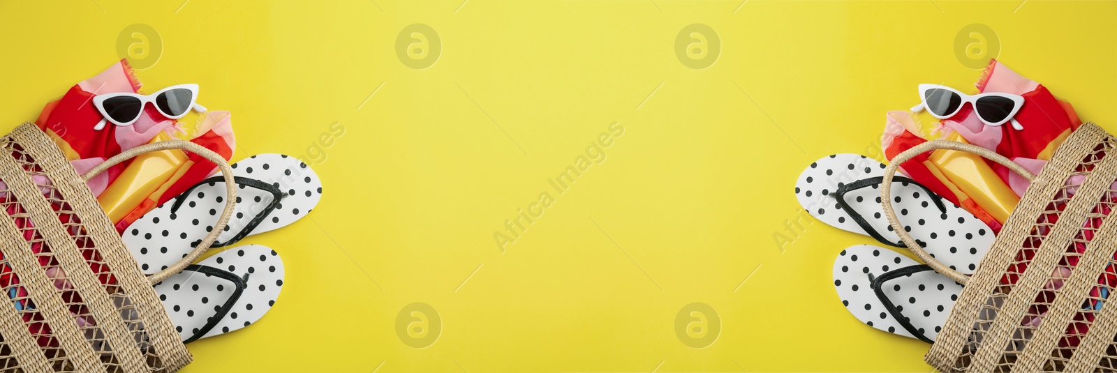 Image of Bags with beach accessories and cosmetic products on yellow background, space for text. Banner design