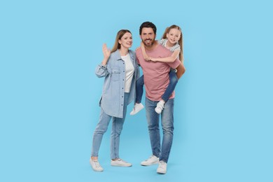 Happy family together on light blue background