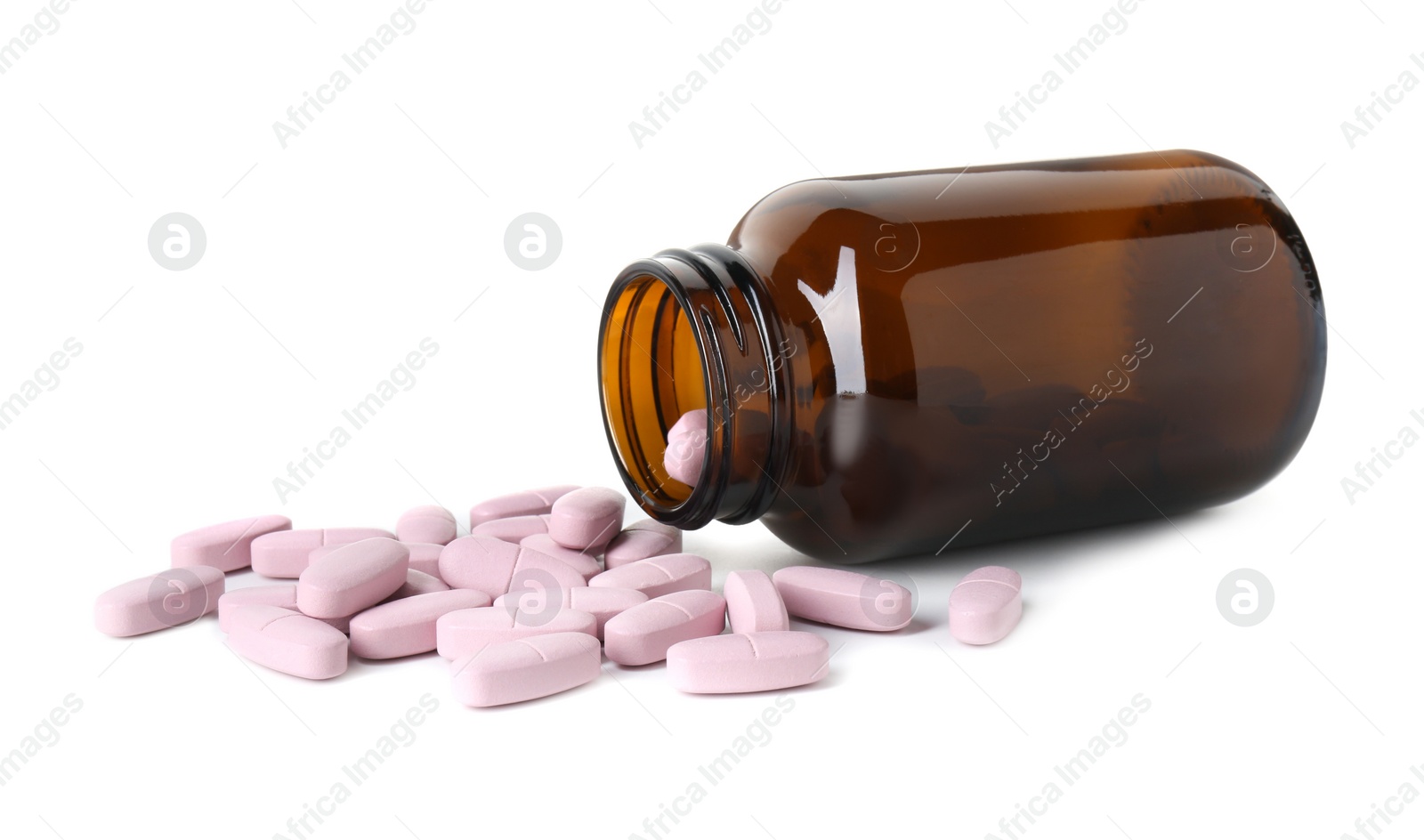 Photo of Scattered vitamin pills and bottle isolated on white