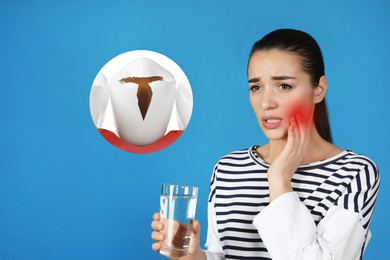 Image of Young woman with glass of water suffering from acute toothache on blue background