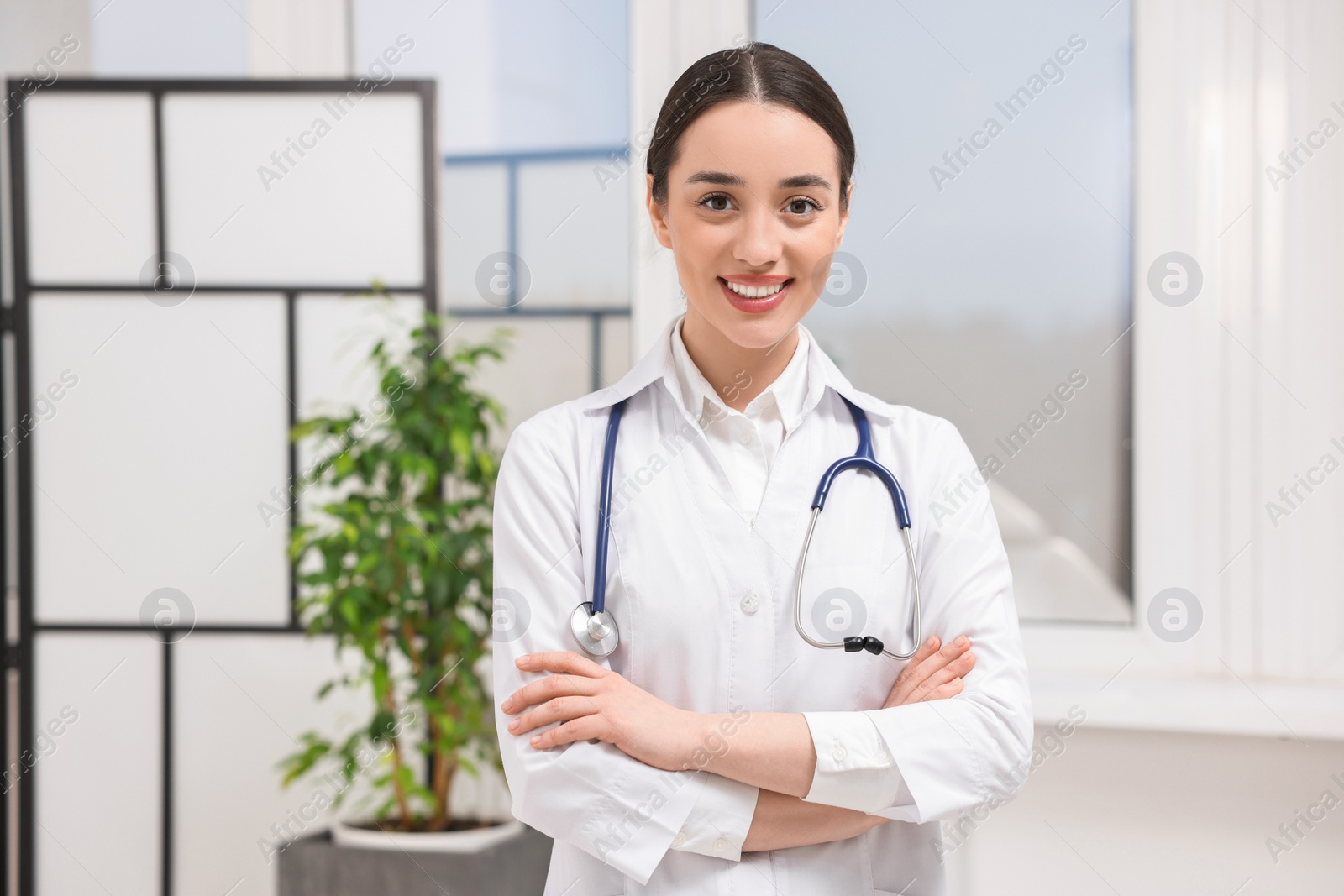 Photo of Portrait of medical consultant with stethoscope in clinic