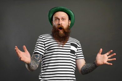 Photo of Bearded man with green hat on grey background. St. Patrick's Day celebration