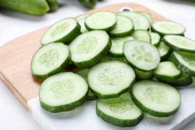 Photo of Slices of fresh ripe cucumber on board, closeup
