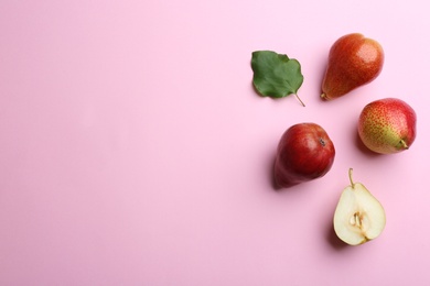 Photo of Ripe juicy pears on pink background, flat lay. Space for text