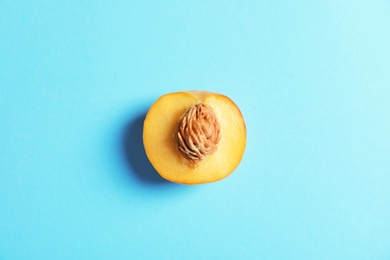 Photo of Half of fresh sweet peach on color background, top view