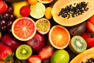 Many different delicious exotic fruits as background, top view