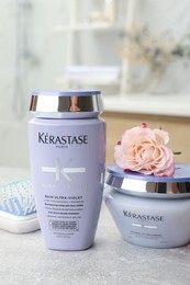 MYKOLAIV, UKRAINE - SEPTEMBER 07, 2021: Kerastase hair care cosmetic products and brush on light table in bathroom