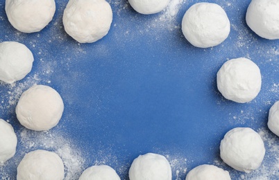 Frame of snowballs on blue background, flat lay. Space for text