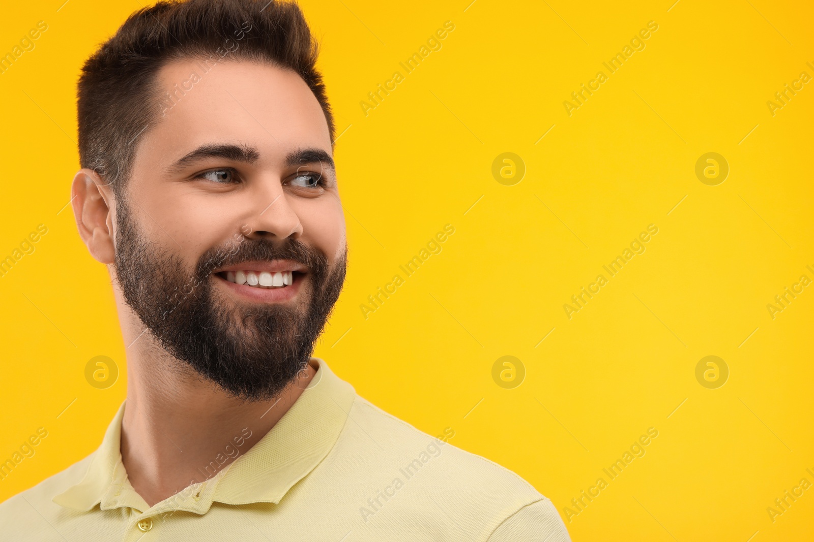 Photo of Man with clean teeth smiling on yellow background, space for text