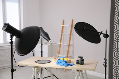 Professional camera and composition with ripe lemons on table in photo studio. Food photography