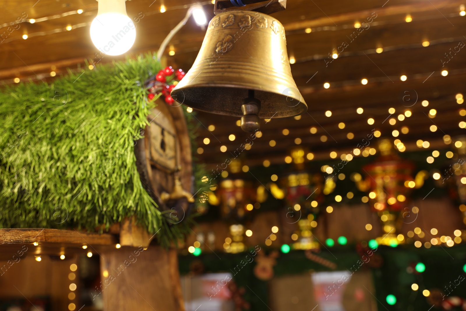 Photo of Decorative bell on blurred background. Christmas fair stall, closeup view