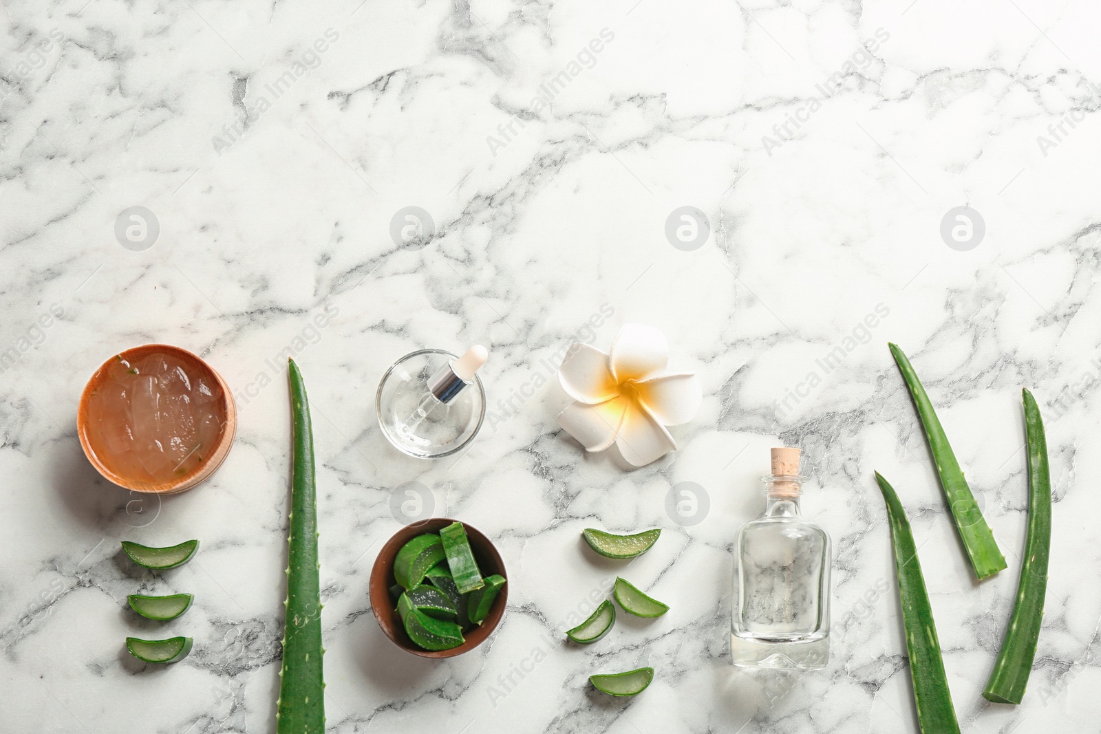 Photo of Flat lay composition with aloe vera leaves on marble background. Space for text