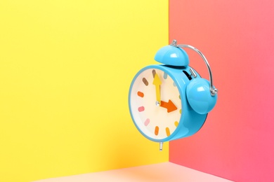 Photo of Alarm clock on color background. Space for text