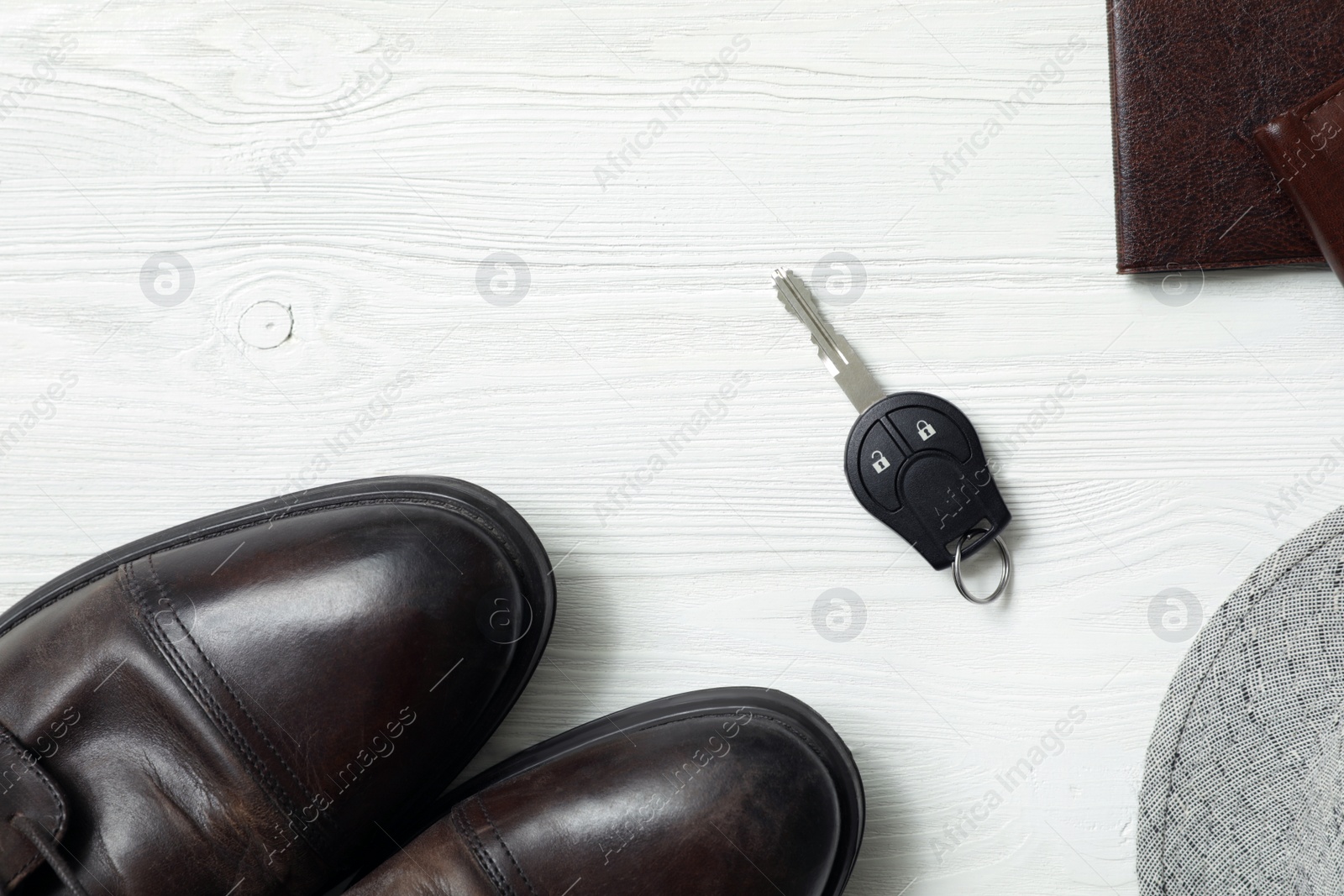 Photo of Flat lay composition with male accessories and car key on white wooden background