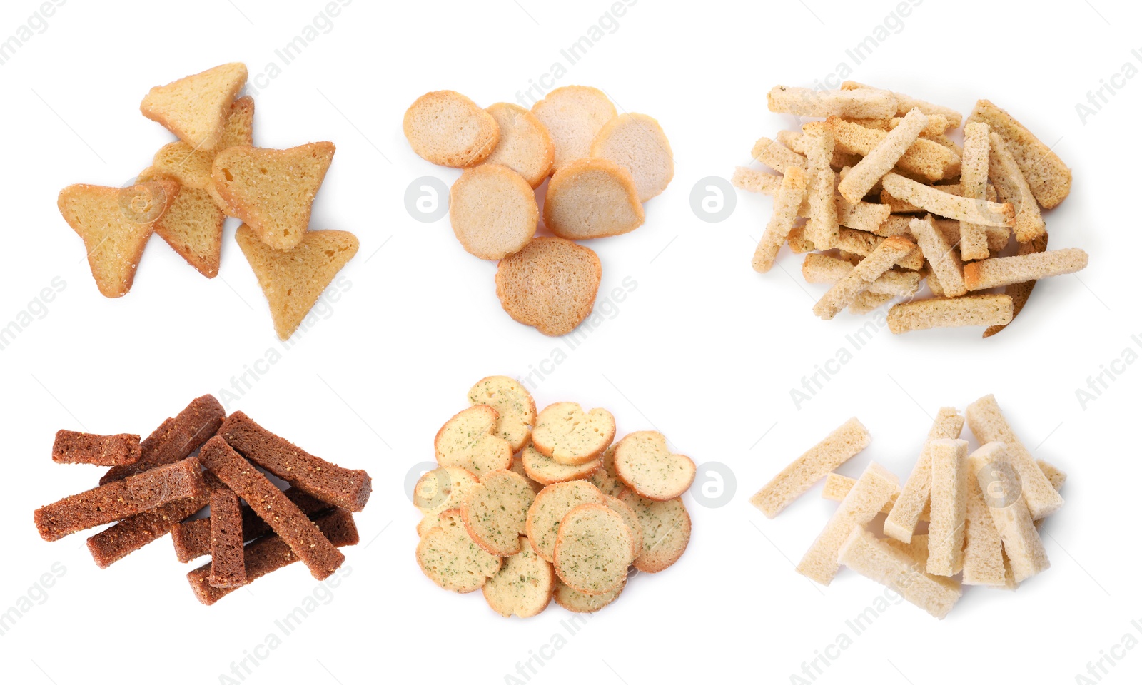 Image of Set with different delicious crispy rusks on white background, top view