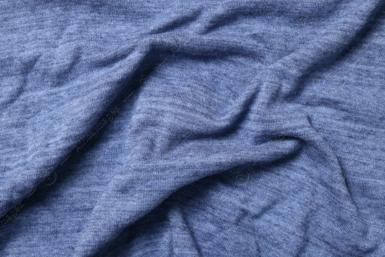 Photo of Texture of blue crumpled fabric as background, top view
