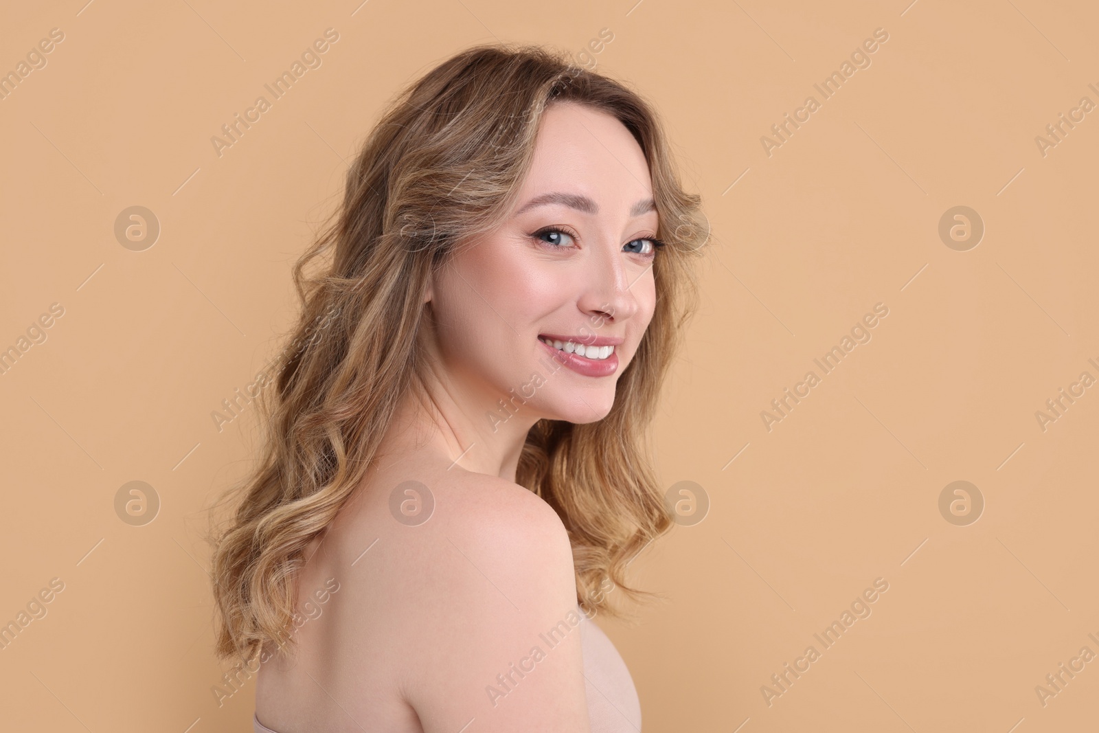 Photo of Portrait of smiling woman on beige background