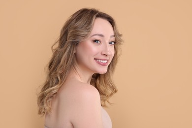 Photo of Portrait of smiling woman on beige background