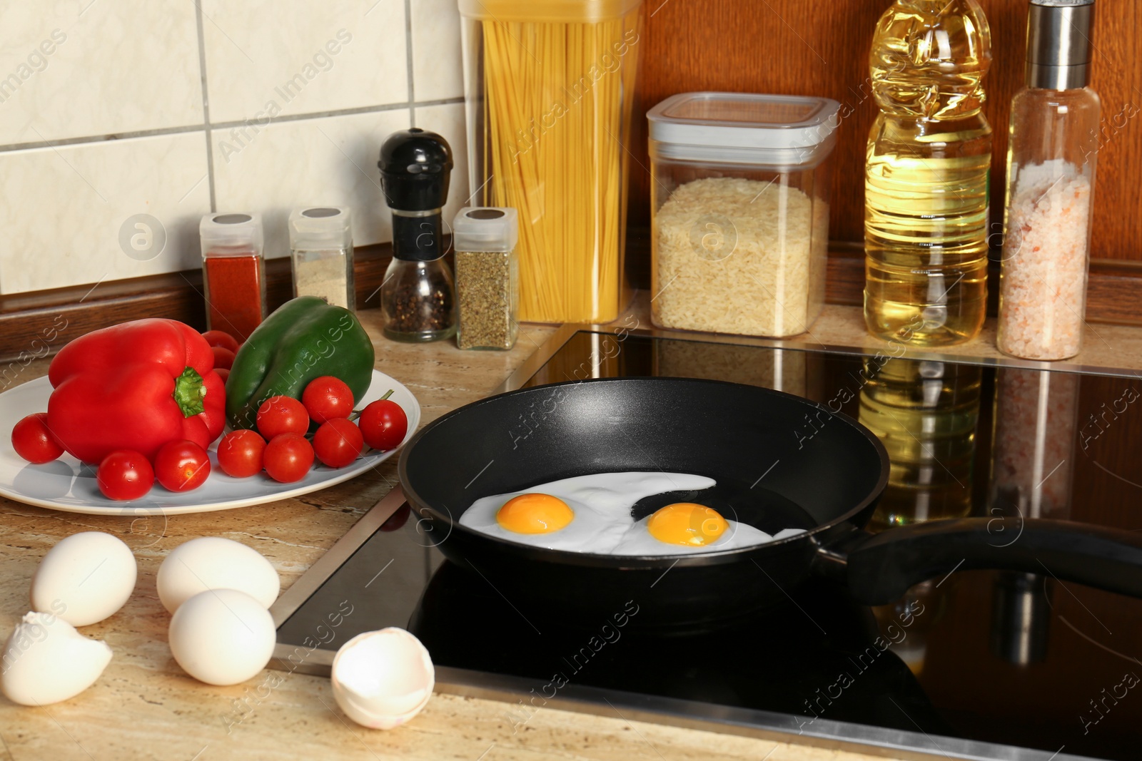 Photo of Cooking eggs for breakfast in frying pan on cooktop