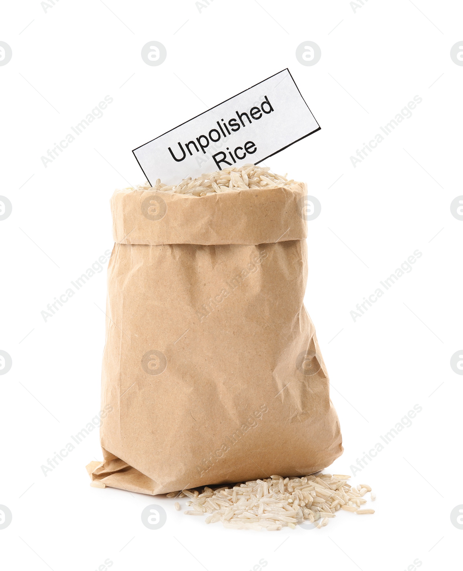 Photo of Paper bag with raw unpolished rice and card on white background