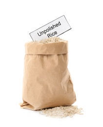 Paper bag with raw unpolished rice and card on white background