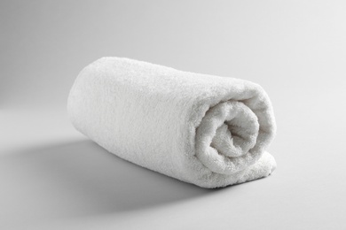 Fresh soft rolled towel on light background