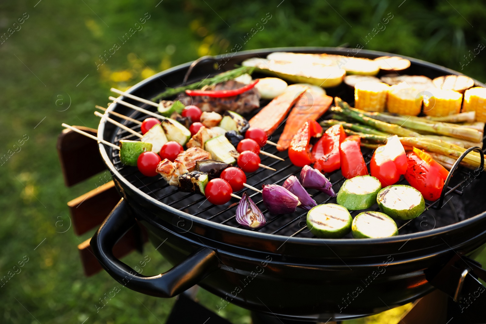 Photo of Delicious grilled vegetables on barbecue grill outdoors, closeup