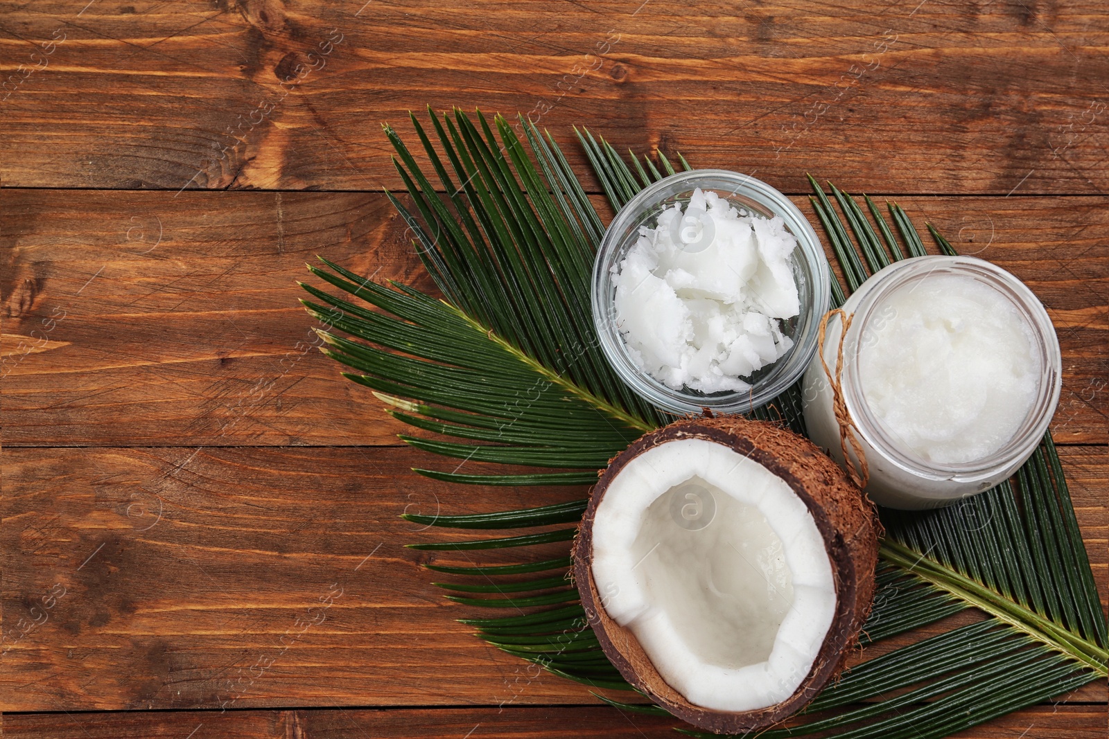 Photo of Flat lay composition with organic coconut oil on wooden table. Healthy cooking