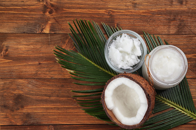 Photo of Flat lay composition with organic coconut oil on wooden table. Healthy cooking