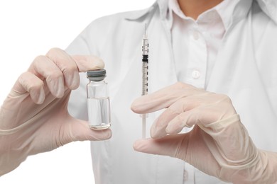 Photo of Doctor holding medical syringe and glass vial on white background, closeup