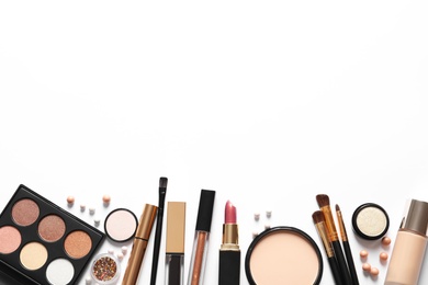 Different luxury makeup products on white background, top view