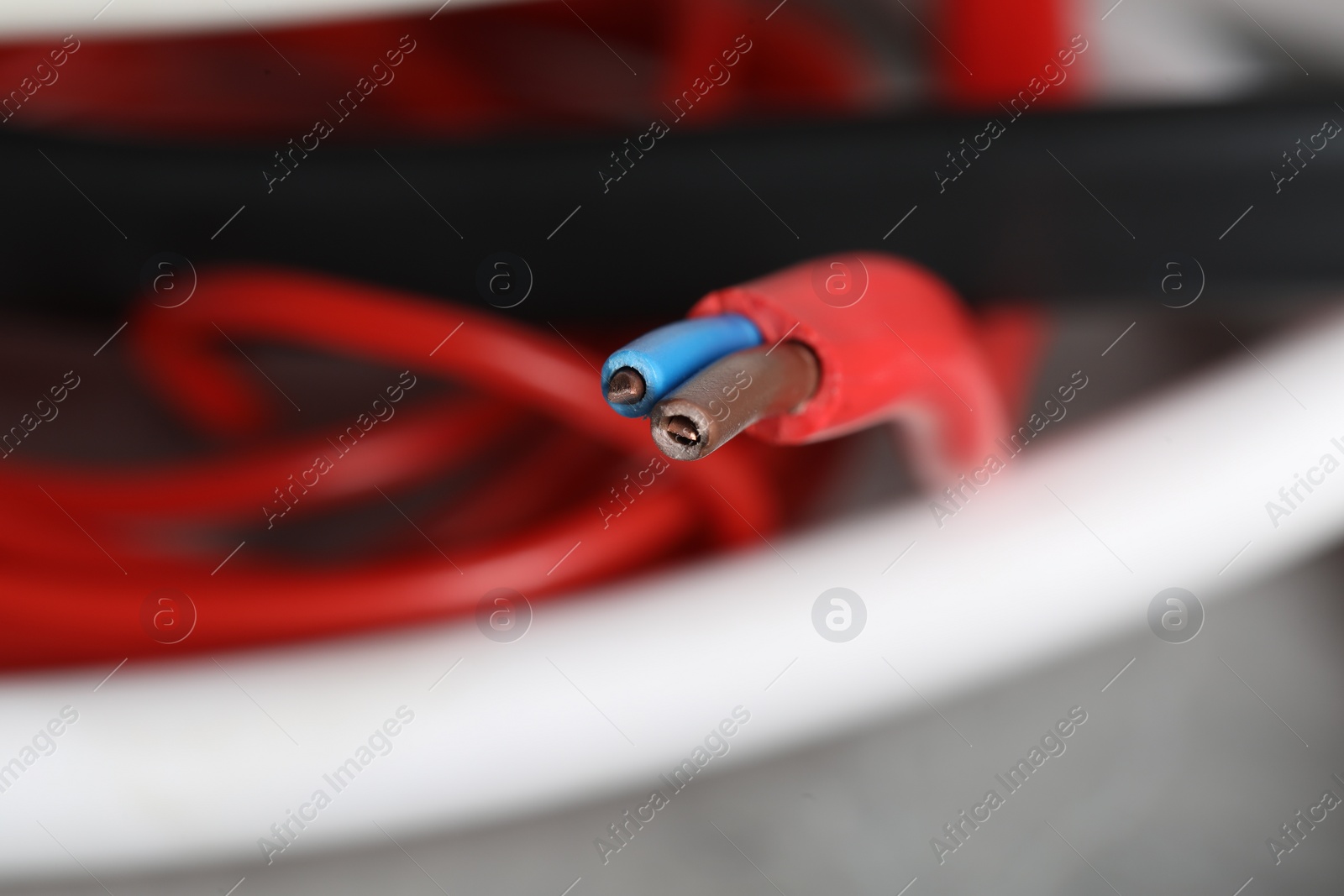 Photo of Colorful electrical wire on blurred background, closeup