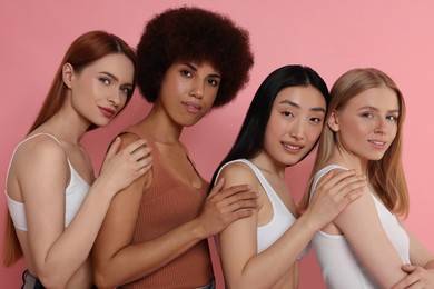 Photo of Portrait of beautiful young women on pink background