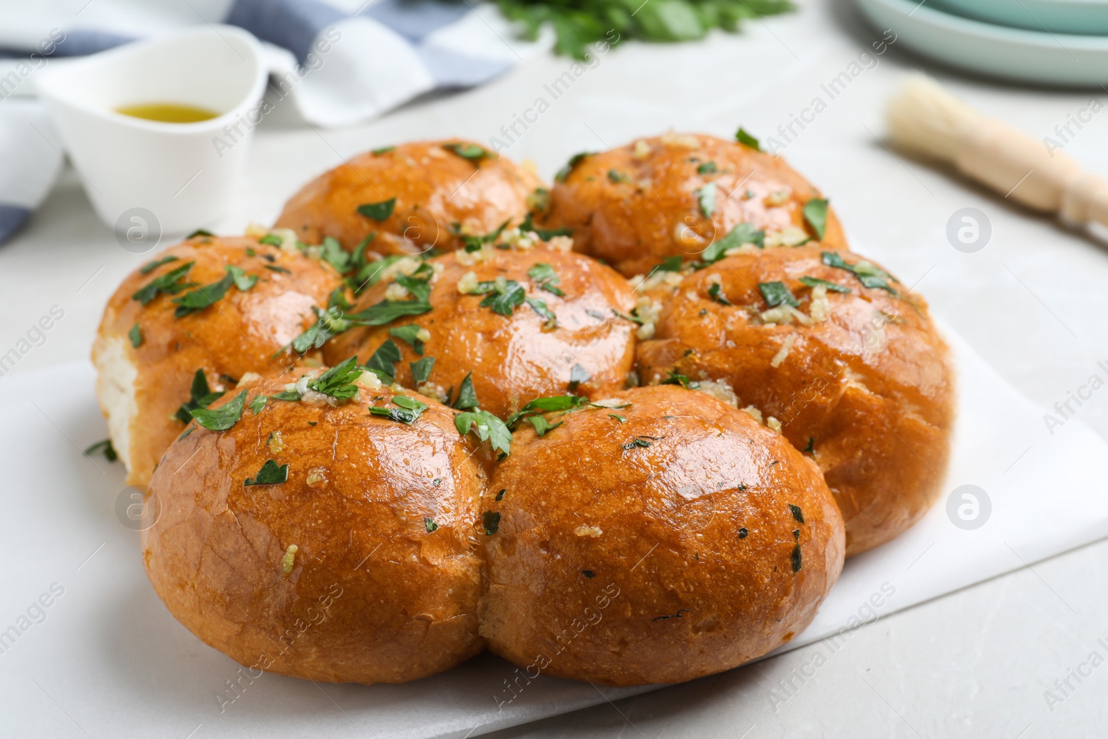 Photo of Traditional Ukrainian garlic bread (Pampushky) on table, closeup