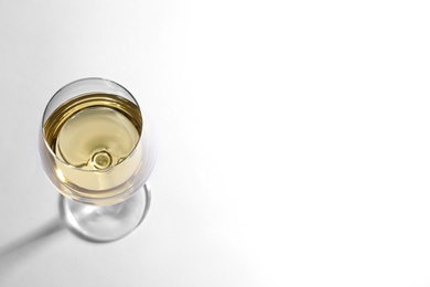 Photo of Glass of delicious wine on white background, above view