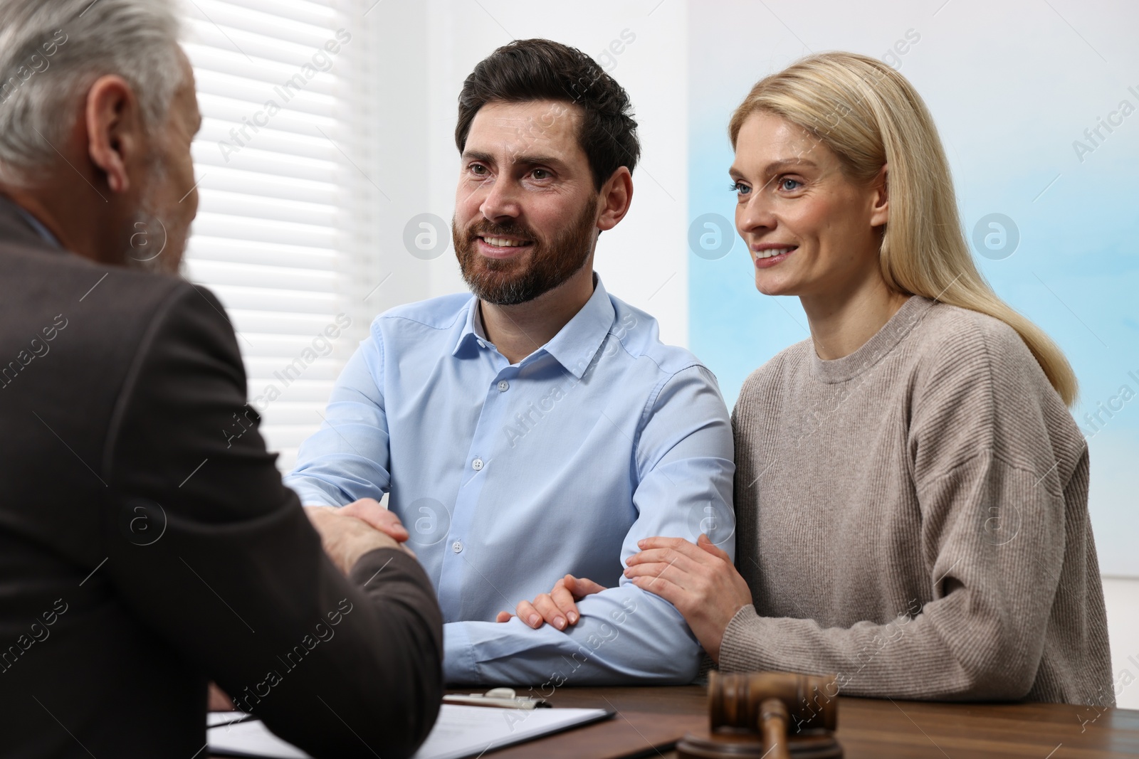 Photo of Couple having meeting with lawyer in office