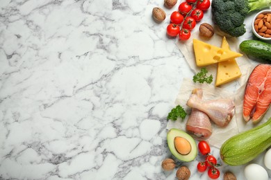 Photo of Flat lay composition with different fresh products on white marble table, space for text. Keto diet