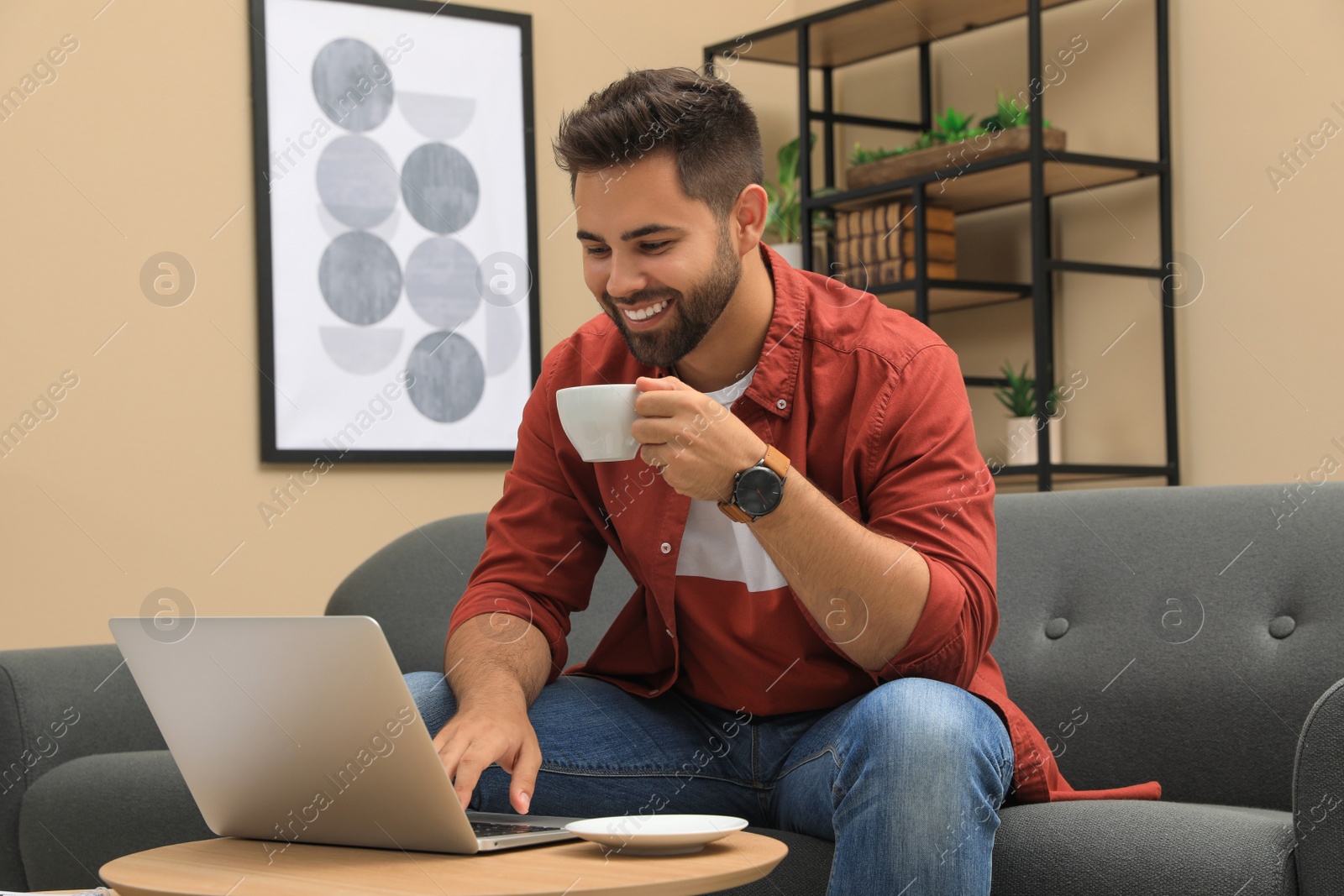 Photo of Man using laptop for online shopping at home