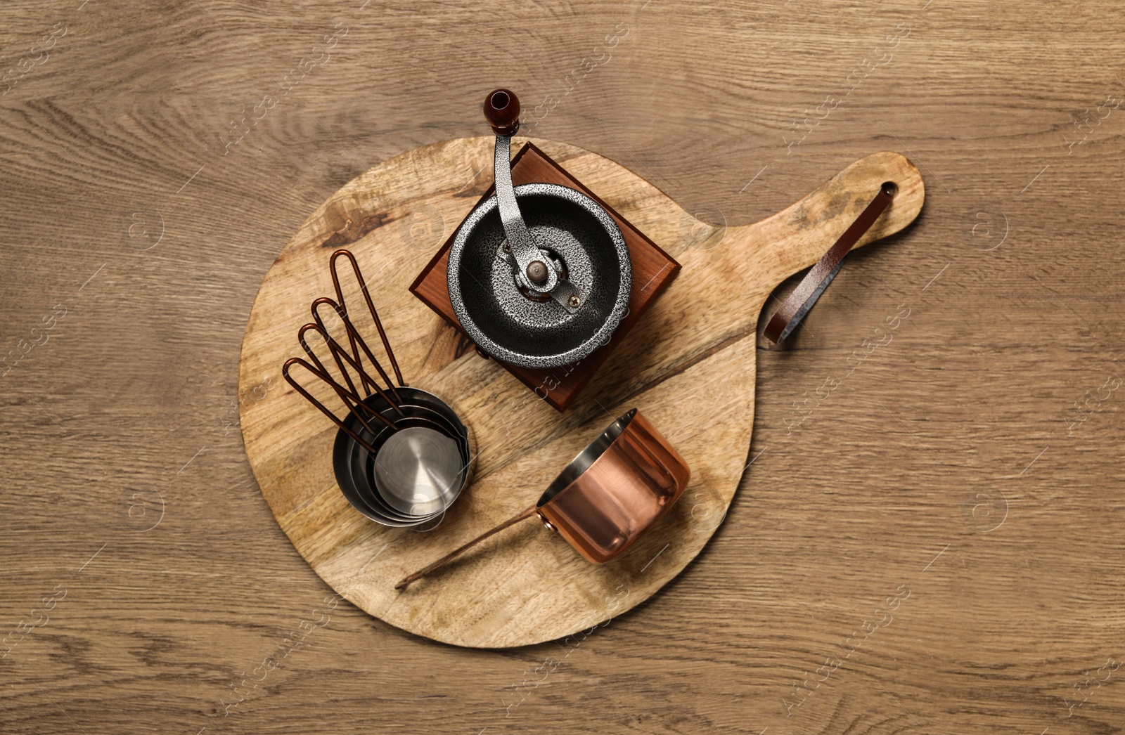 Photo of Set of cooking utensils on wooden table, top view