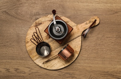 Set of cooking utensils on wooden table, top view