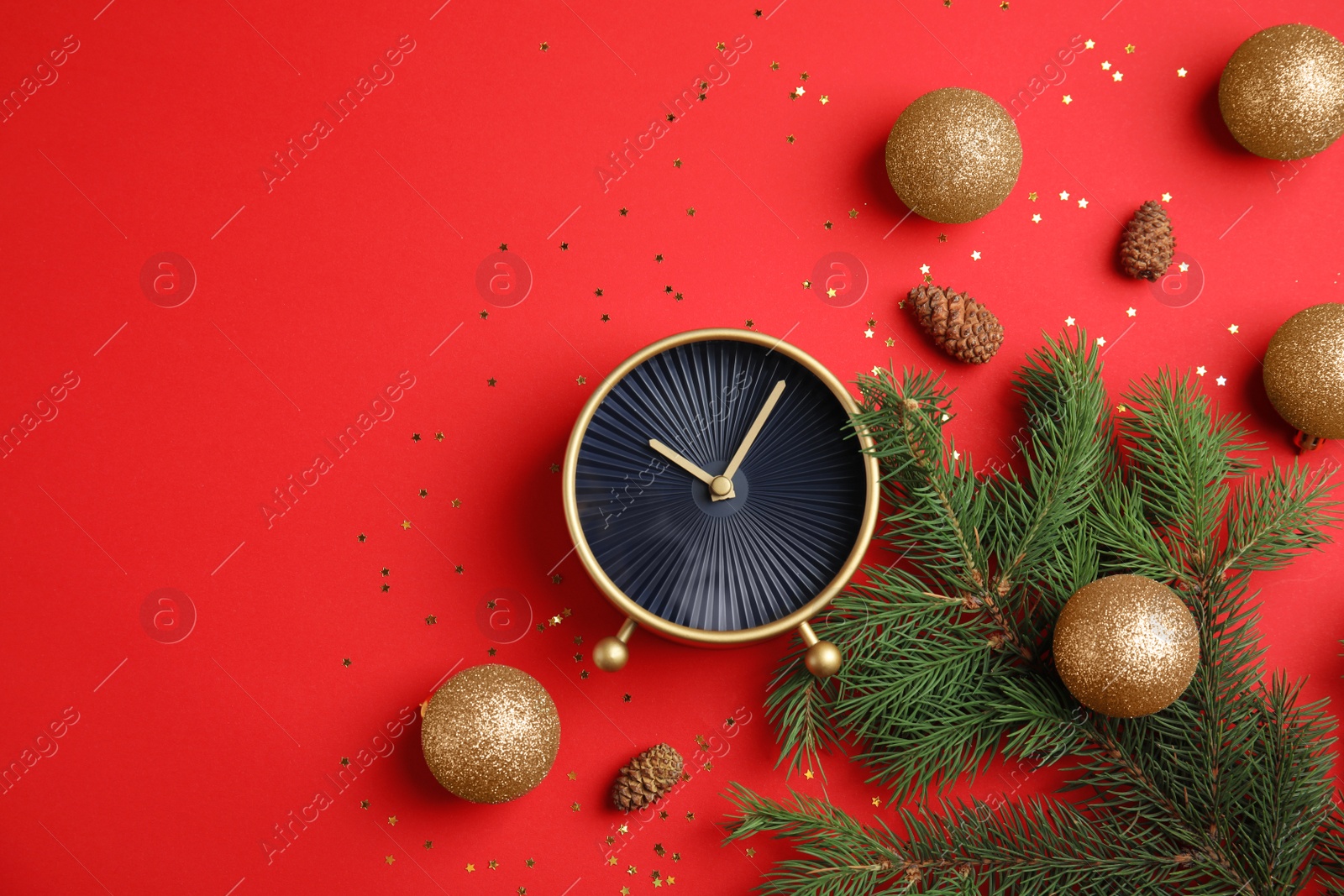 Photo of Flat lay composition with alarm clock, fir branches and beautiful decorations on color background. Christmas countdown