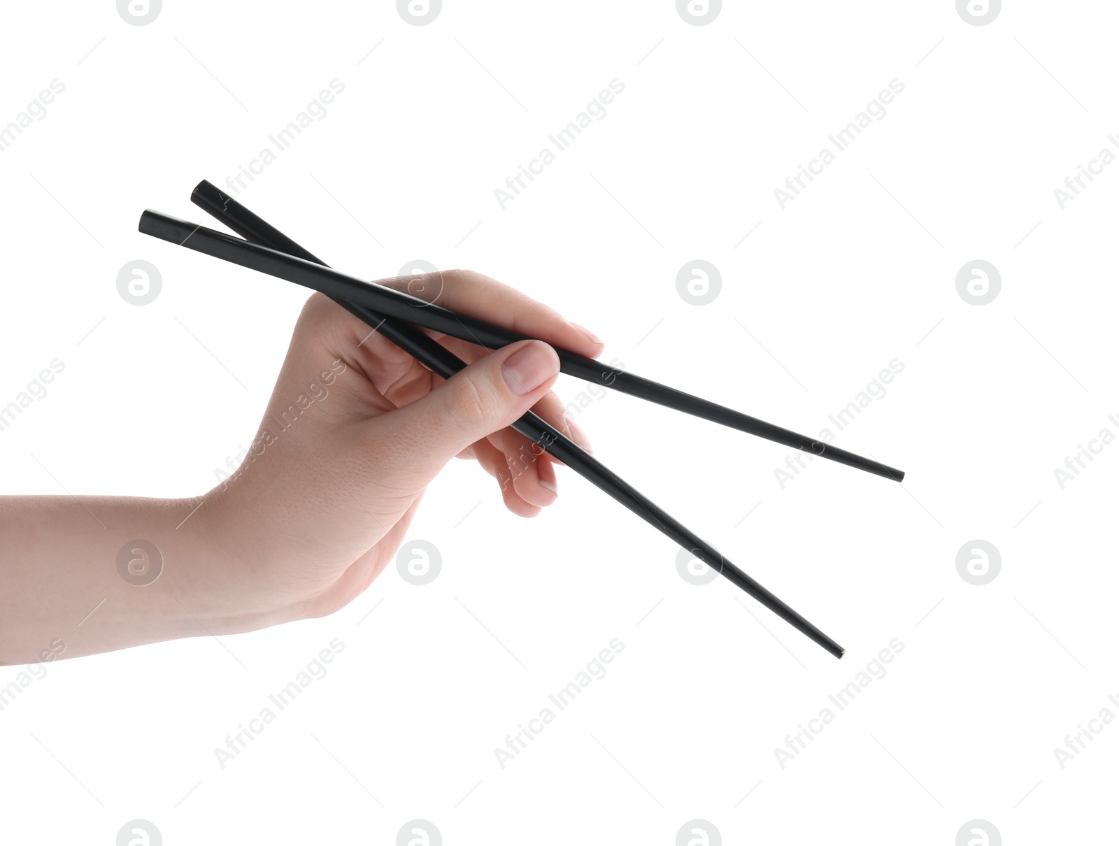 Photo of Woman holding pair of black chopsticks on white background, closeup