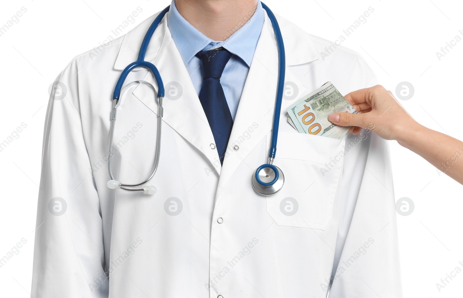 Photo of Patient putting bribe into doctor's pocket on white background, closeup. Corruption in medicine
