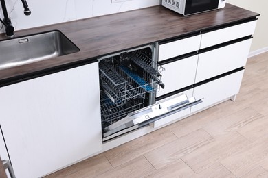 Photo of Built-in dishwasher with open door in kitchen, above view